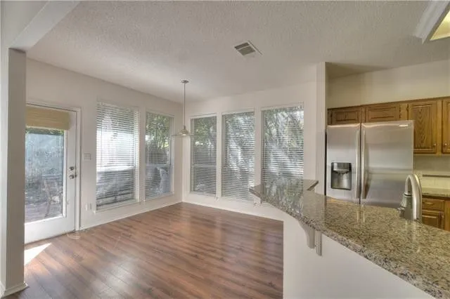 a view of a room with wooden floor and sliding glass door
