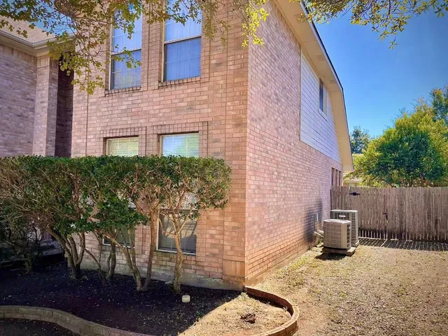 a backyard of a house with outdoor seating