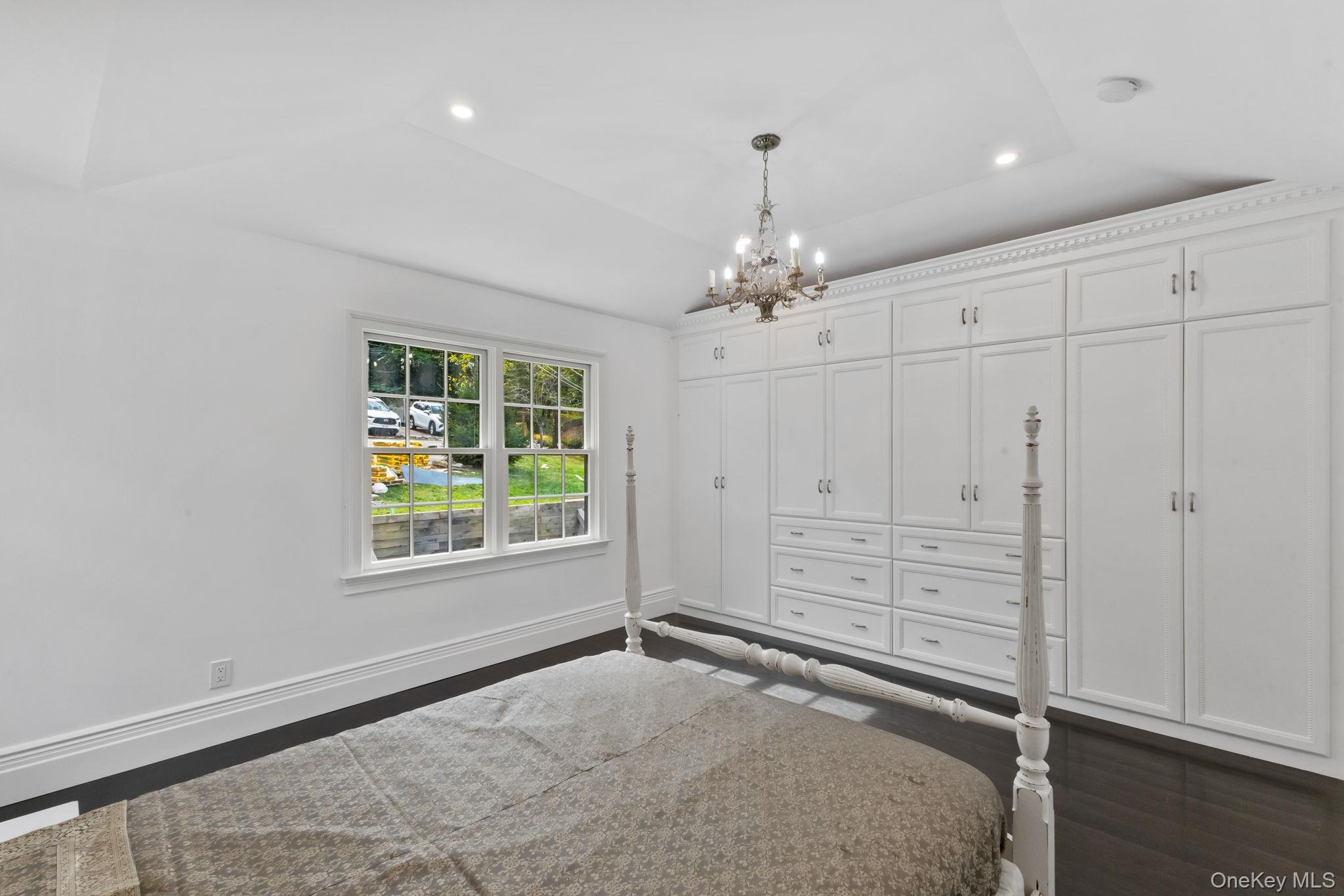 675 Quaker Road Chappaqua, NY 10514 - Photo 12 of 34 wooden floor in an empty room with a window