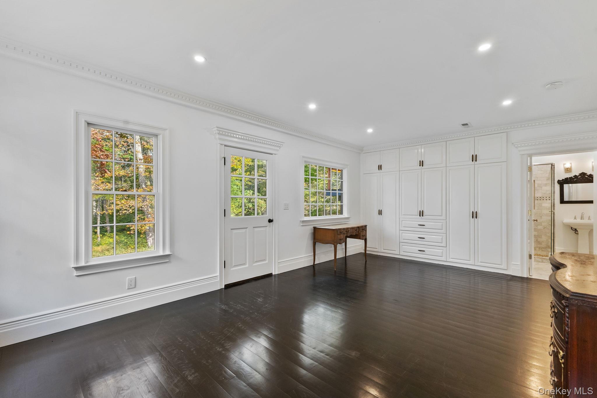 675 Quaker Road Chappaqua, NY 10514 - Photo 21 of 34 a view of an empty room with wooden floor and a window