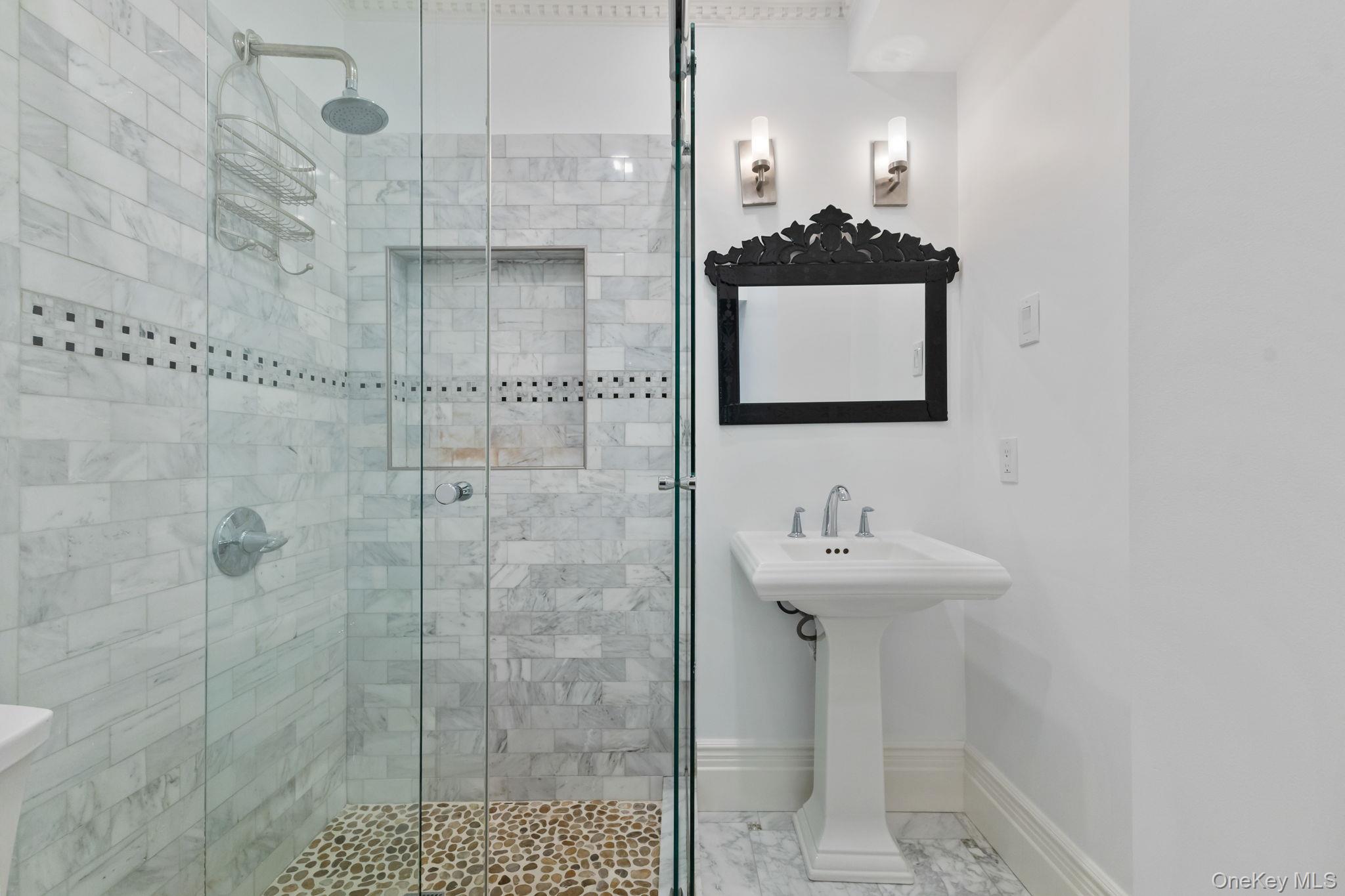 675 Quaker Road Chappaqua, NY 10514 - Photo 22 of 34 a bathroom with a sink a mirror and shower