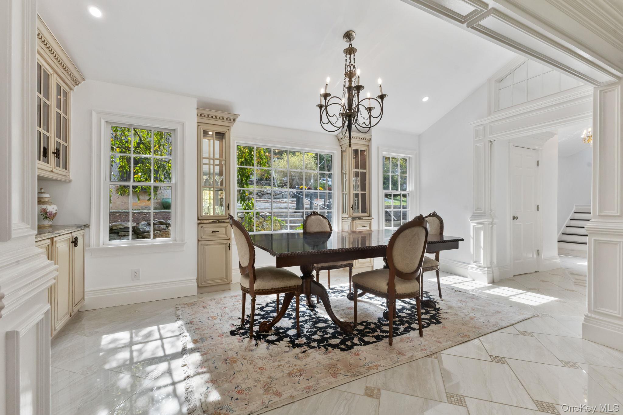 675 Quaker Road Chappaqua, NY 10514 - Photo 3 of 34 a view of a dining room with furniture and a chandelier