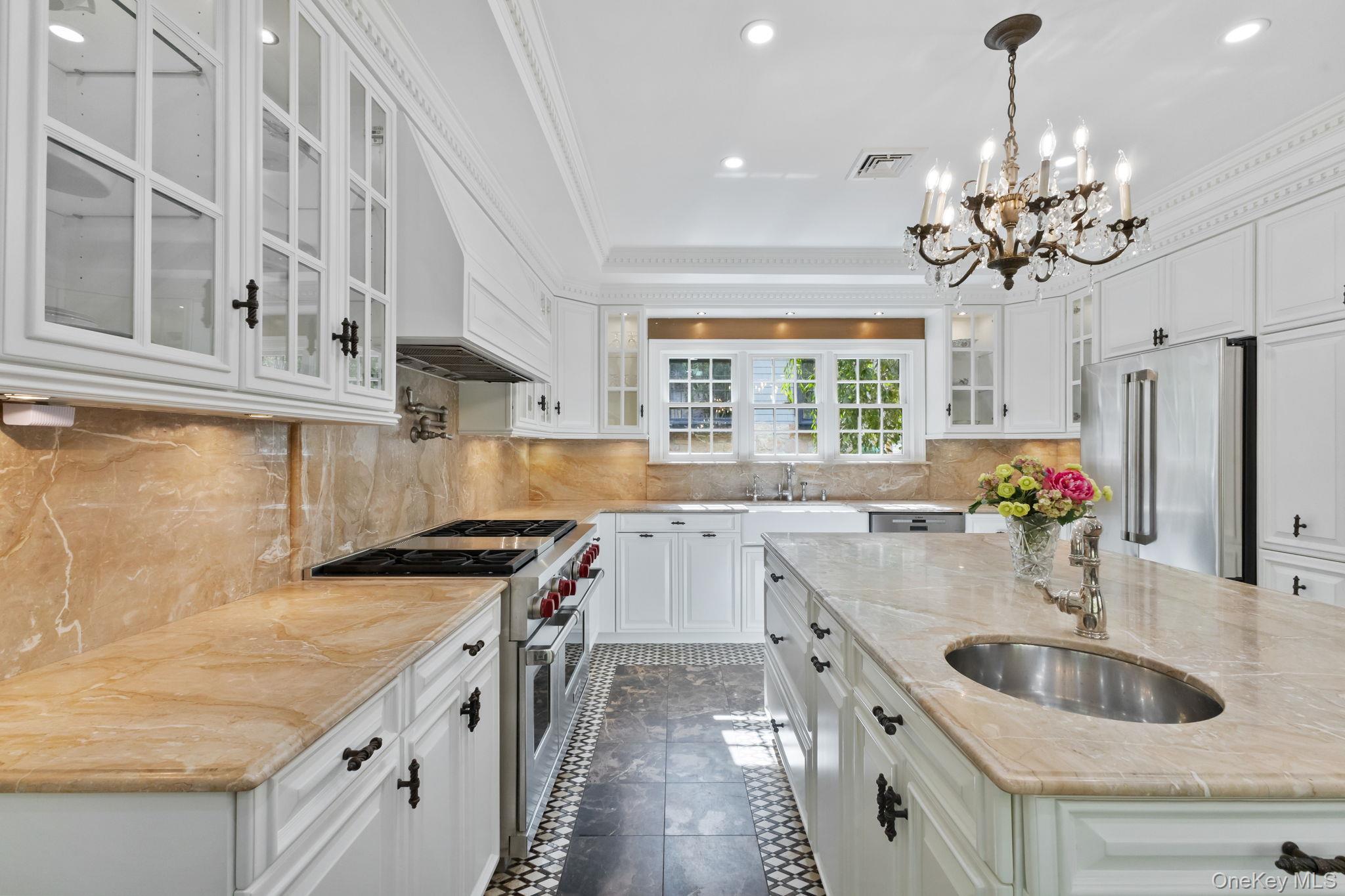 675 Quaker Road Chappaqua, NY 10514 - Photo 34 of 34 a kitchen with a sink stove top oven and chandelier
