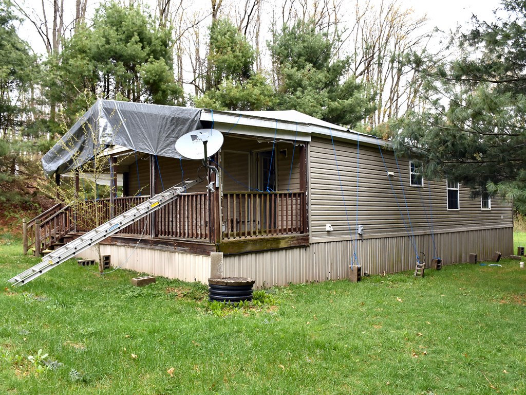 28762 Deckards Road Cochranton, PA 16314 - Photo 3 of 18 a view of a house with a yard and furniture
