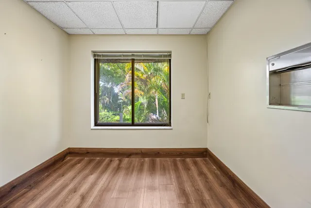 a view of an empty room with wooden floor