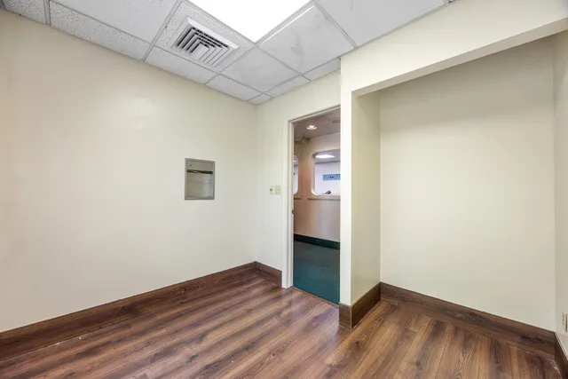 a view of an empty room and wooden floor