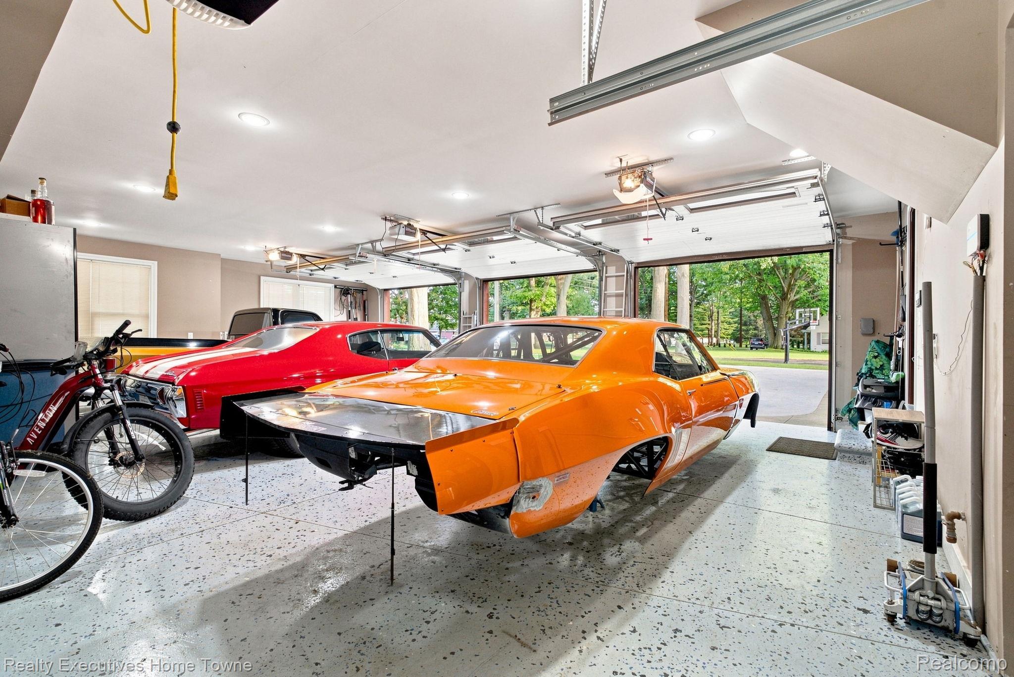 2829 Riverside Drive Port Huron, MI 48060 - Photo 84 of 99 Spacious garage featuring a durable epoxy floor, recessed lighting, and multiple automatic garage doors