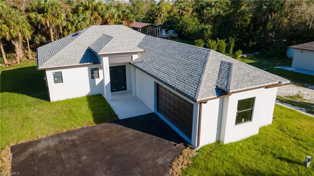 a aerial view of a house with a yard and potted plants