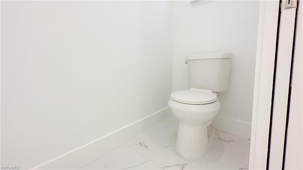 1028 19th Street Southwest Naples, FL 34117 - Photo 21 of 50 a white toilet sitting next to a white sink