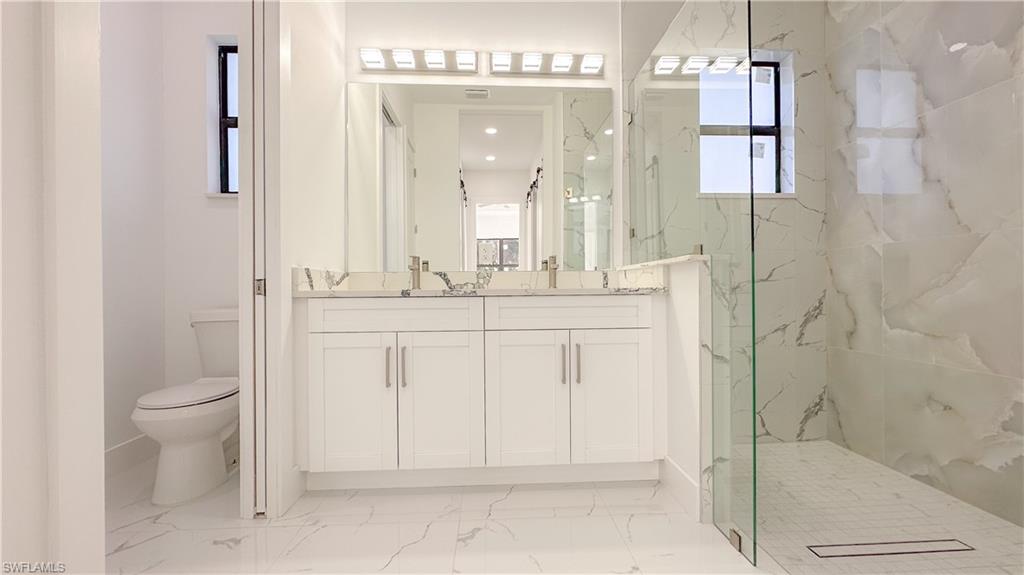 1028 19th Street Southwest Naples, FL 34117 - Photo 22 of 50 a bathroom with a sink a toilet and shower