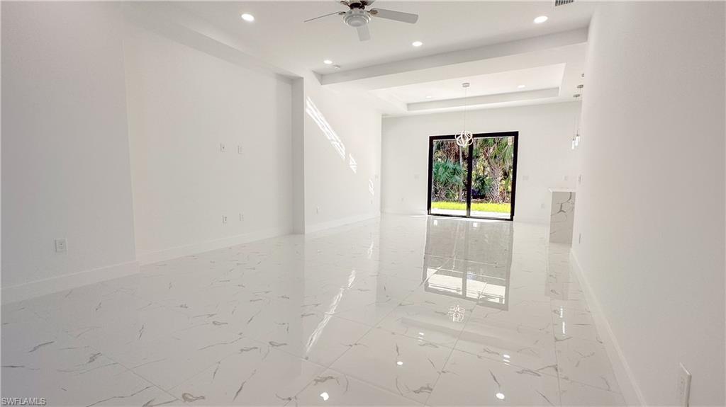 1028 19th Street Southwest Naples, FL 34117 - Photo 27 of 50 en empty room with windows and a ceiling fan