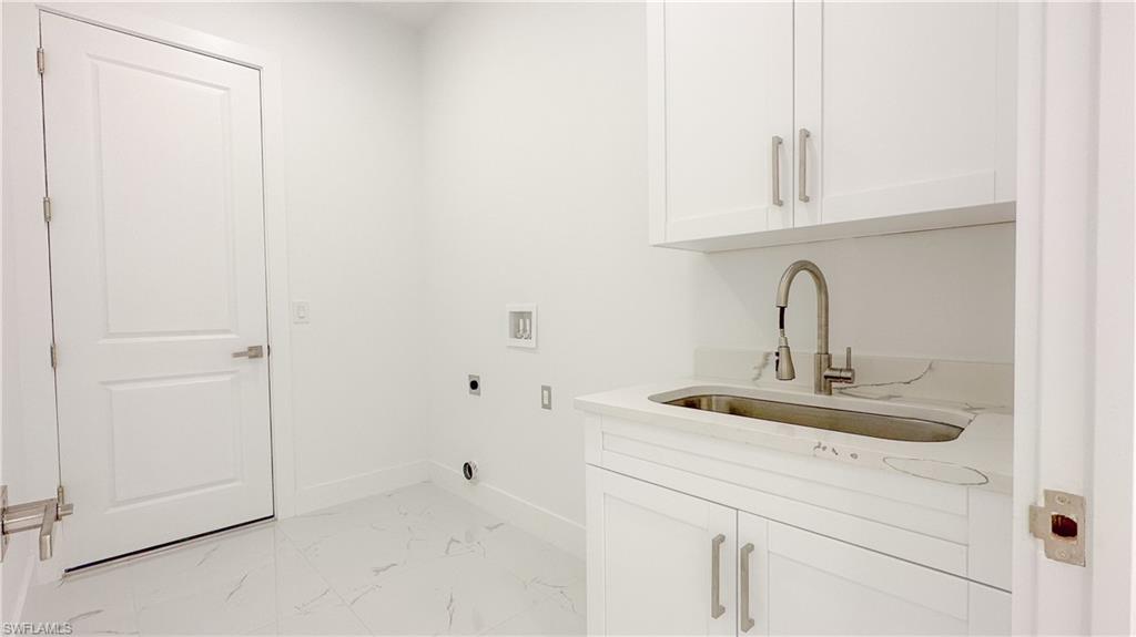 1028 19th Street Southwest Naples, FL 34117 - Photo 28 of 50 a bathroom with a sink and vanity