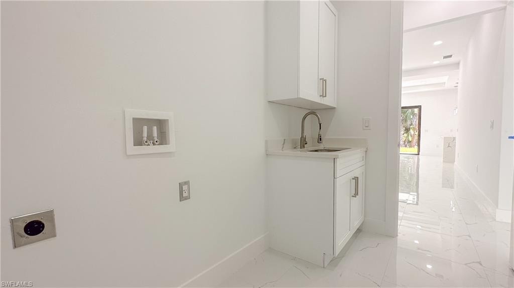 1028 19th Street Southwest Naples, FL 34117 - Photo 29 of 50 a bathroom with a granite countertop sink