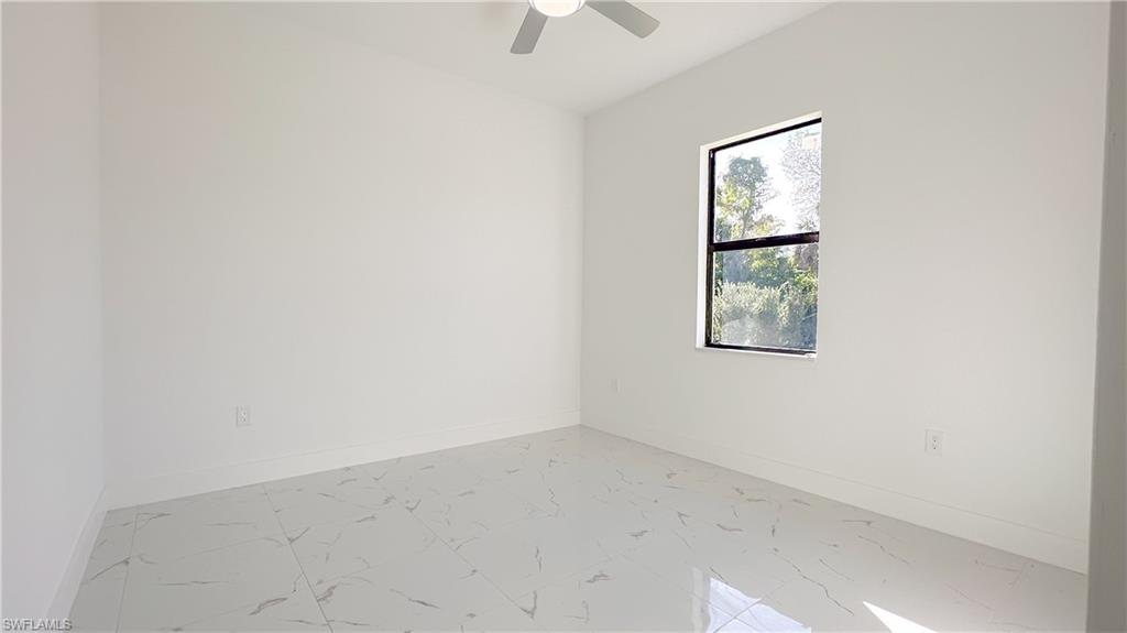 1028 19th Street Southwest Naples, FL 34117 - Photo 30 of 50 an empty room with a fan & a window