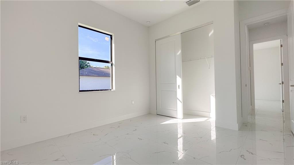 1028 19th Street Southwest Naples, FL 34117 - Photo 31 of 50 an empty room with windows and entrance