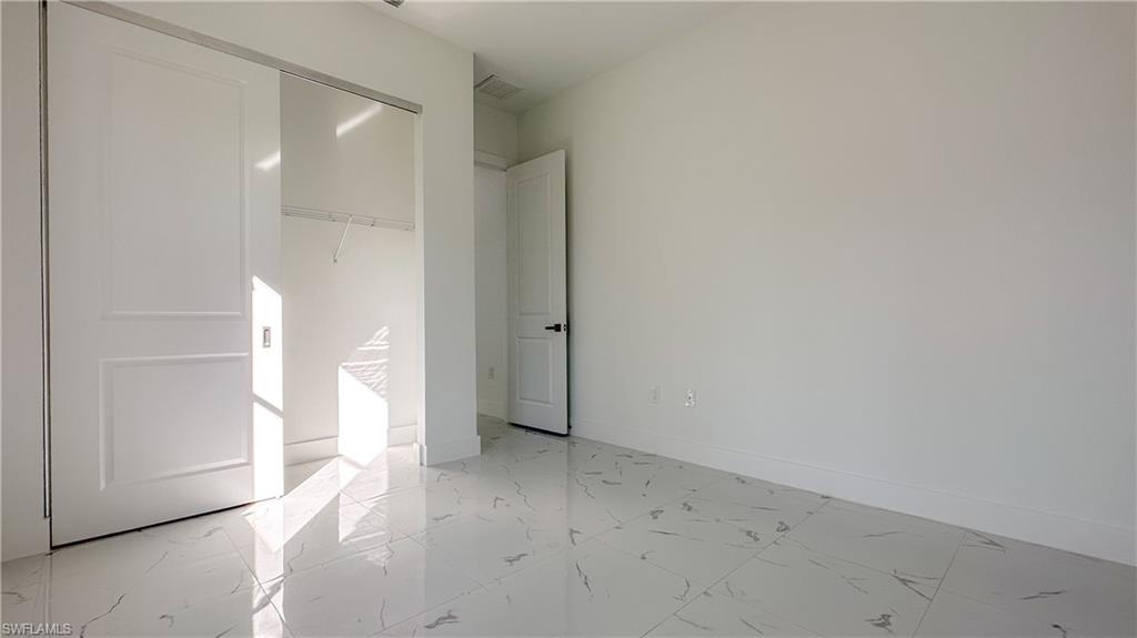 1028 19th Street Southwest Naples, FL 34117 - Photo 32 of 50 wooden floor in an empty room