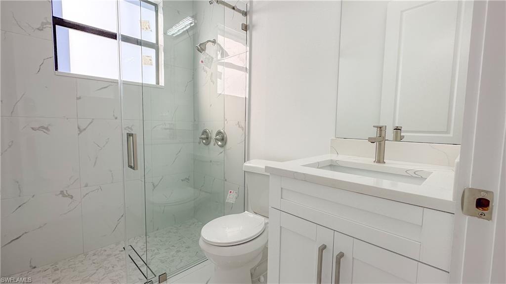1028 19th Street Southwest Naples, FL 34117 - Photo 34 of 50 a bathroom with a sink a toilet and shower