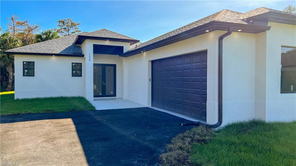 1028 19th Street Southwest Naples, FL 34117 - Photo 4 of 50 a view of a house with a yard