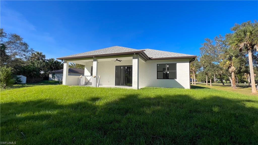 1028 19th Street Southwest Naples, FL 34117 - Photo 42 of 50 a view of a house with a yard
