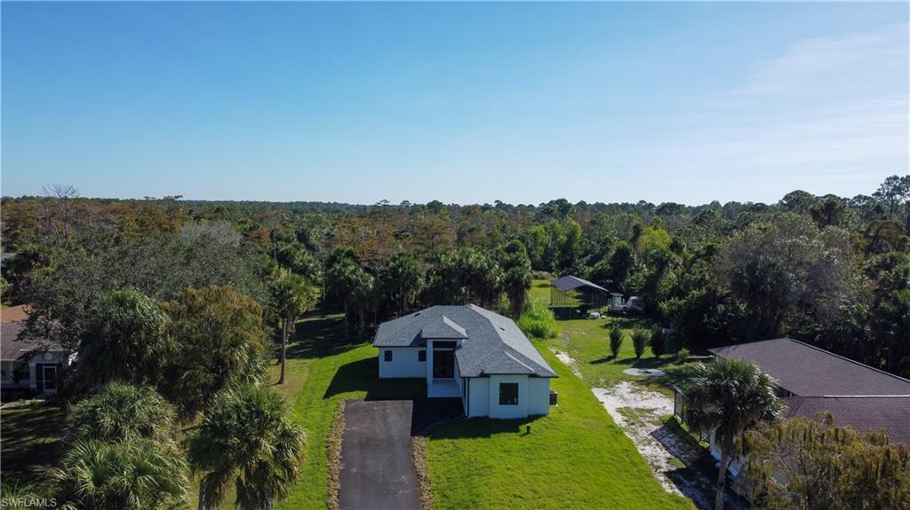 1028 19th Street Southwest Naples, FL 34117 - Photo 45 of 50 an aerial view of residential house with outdoor space and trees all around