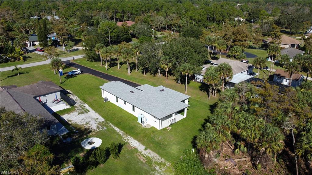 1028 19th Street Southwest Naples, FL 34117 - Photo 46 of 50 an aerial view of a house with a garden and swimming pool