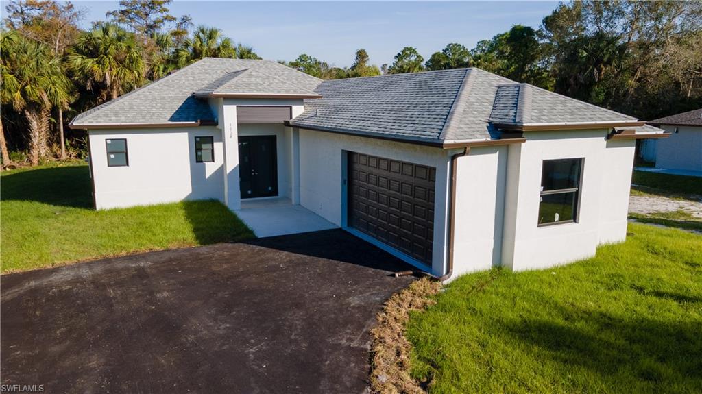 1028 19th Street Southwest Naples, FL 34117 - Photo 48 of 50 a aerial view of a house with yard and garage
