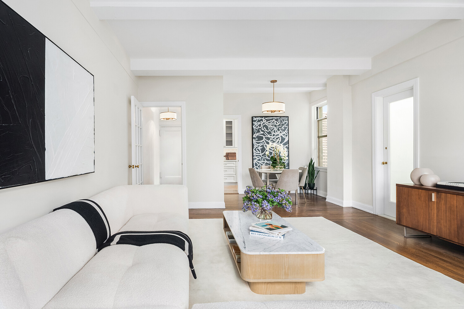 131 East 93rd Street, Unit 7A Manhattan, NY 10128 - Photo 3 of 8 a living room with furniture flowerpot and wooden floor