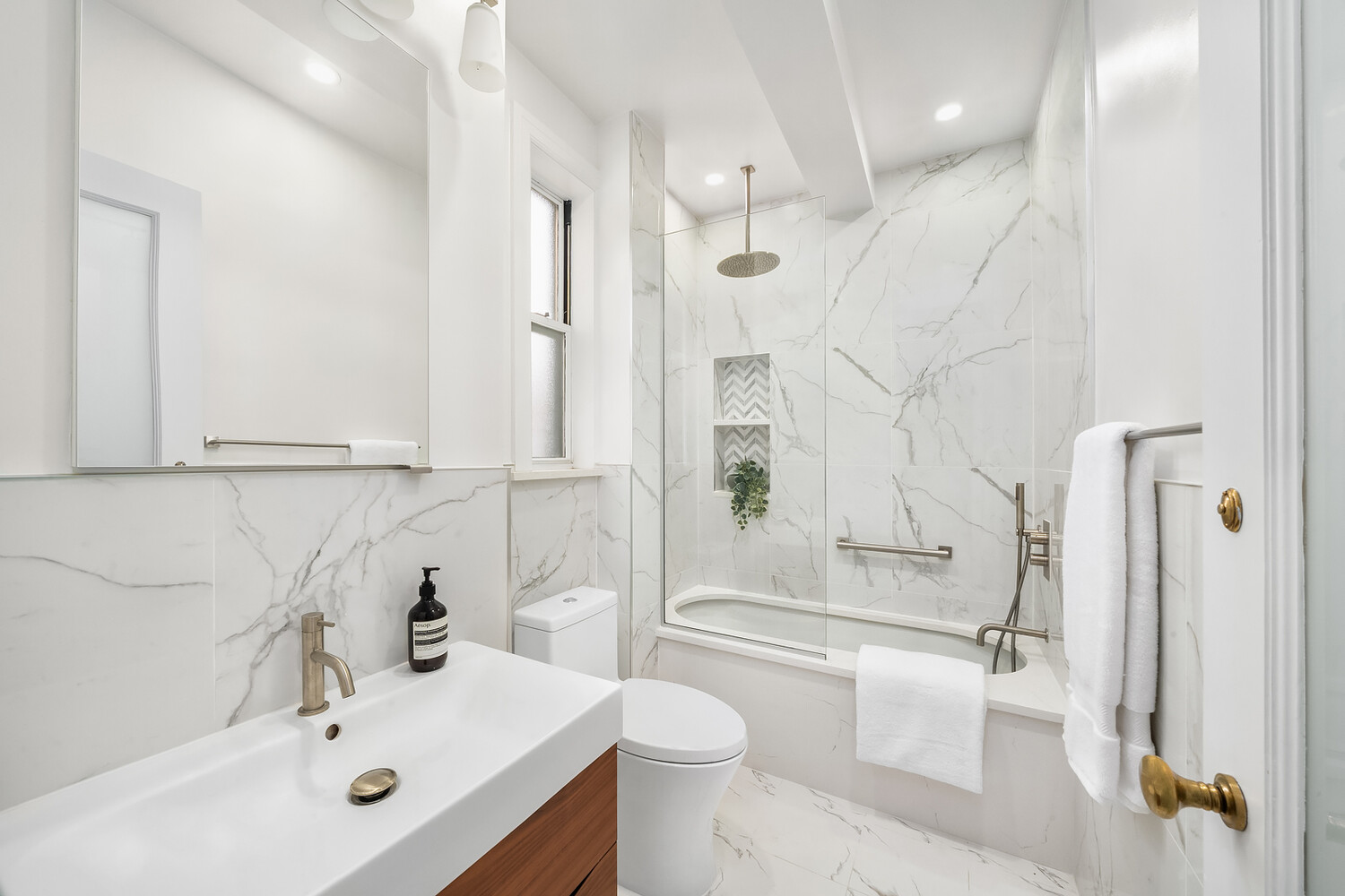 131 East 93rd Street, Unit 7A Manhattan, NY 10128 - Photo 7 of 8 a bathroom with a sink toilet and shower