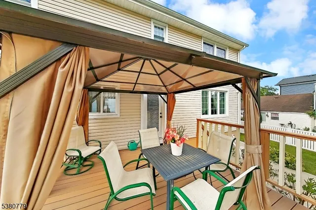 a view of a chairs and table in the balcony