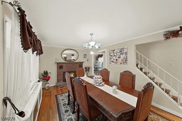 a view of a dining room with furniture wooden floor and a chandelier