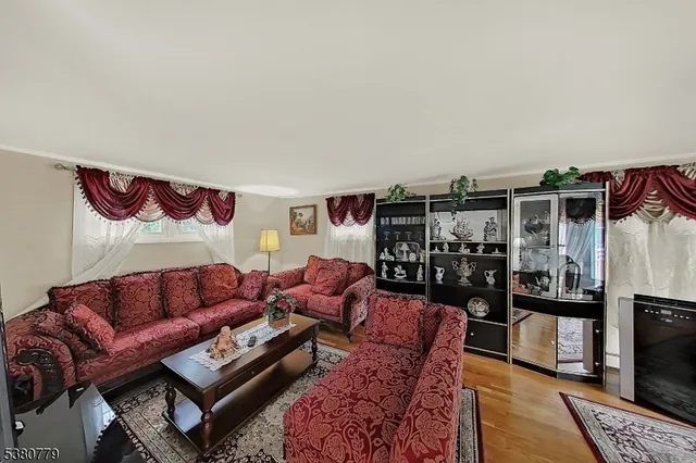 a living room with furniture a rug and a table
