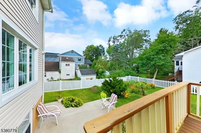 a view of house with a yard and furniture