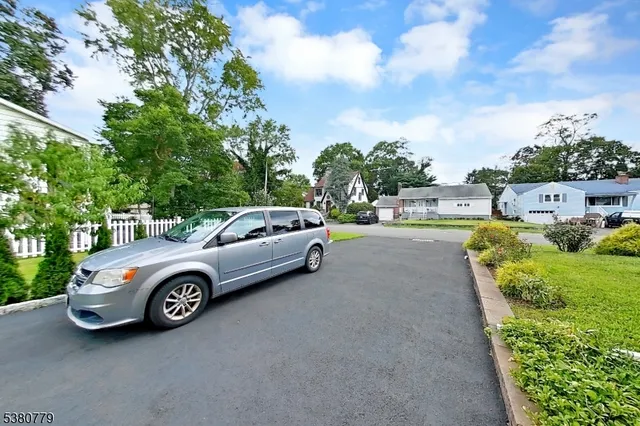a view of a cars park in front of a house