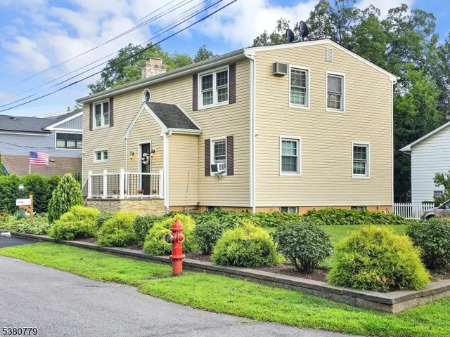 a white house with yard in front of it
