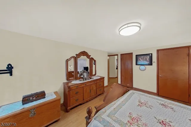 a bedroom with a bed and a dresser in it