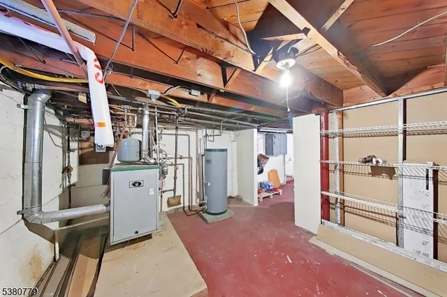 a view of water heater room with stairs