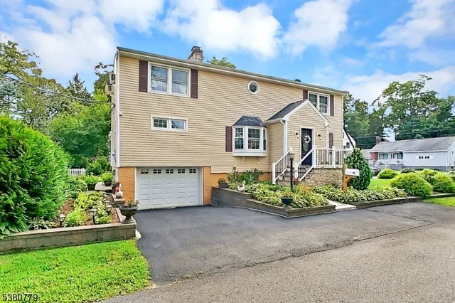 a front view of a house with a garden