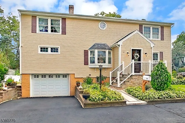 a view of a house with a small yard and a large window