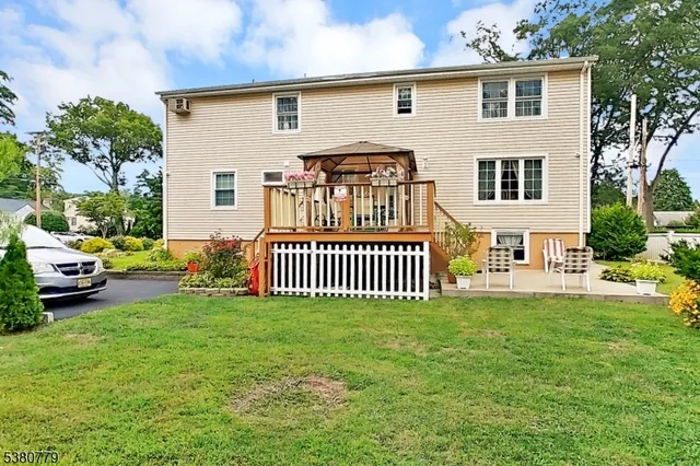 a view of a house with a yard and a porch