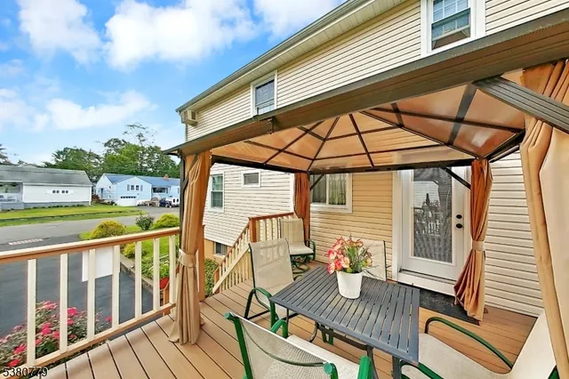 a view of an outdoor sitting area with furniture and wooden floor