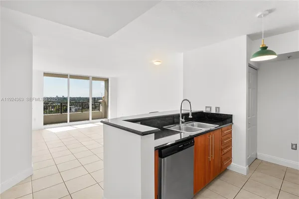 a kitchen with granite countertop a sink and a stove