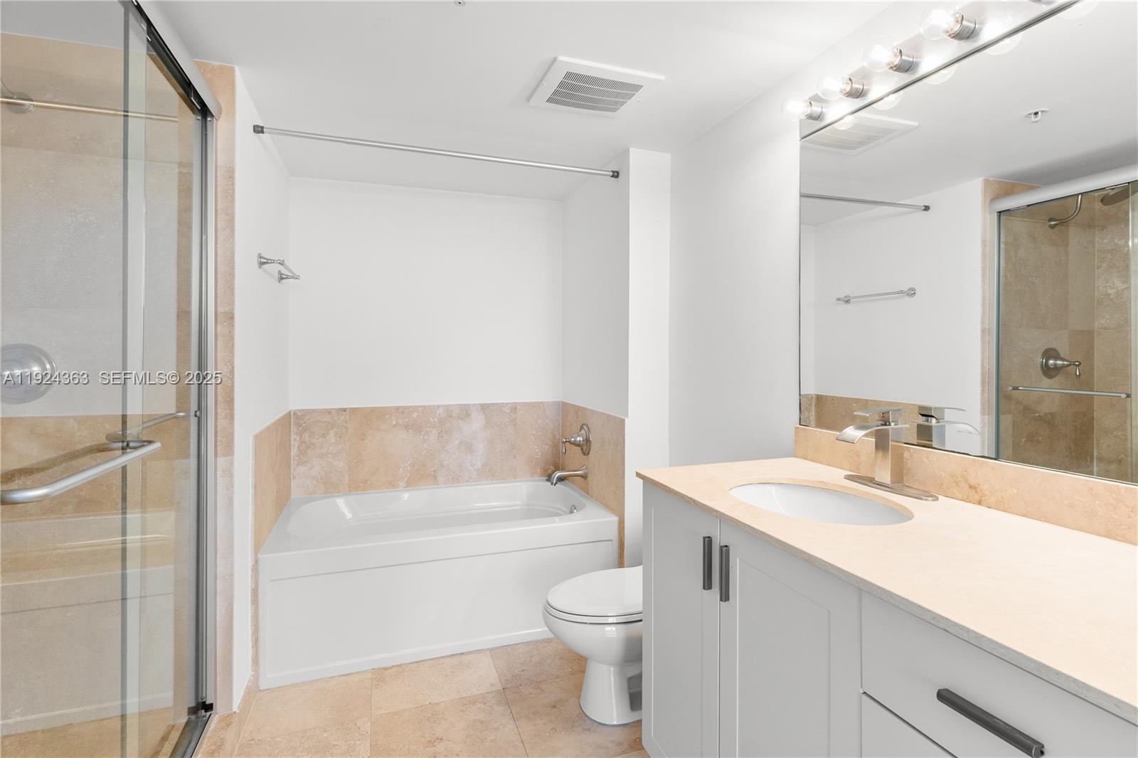 3232 Southwest 22nd Street, Unit 905 Miami, FL 33145 - Photo 12 of 24 a bathroom with a sink a toilet and shower