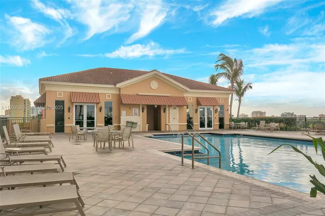 a view of a patio with table and chairs with wooden floor and fence