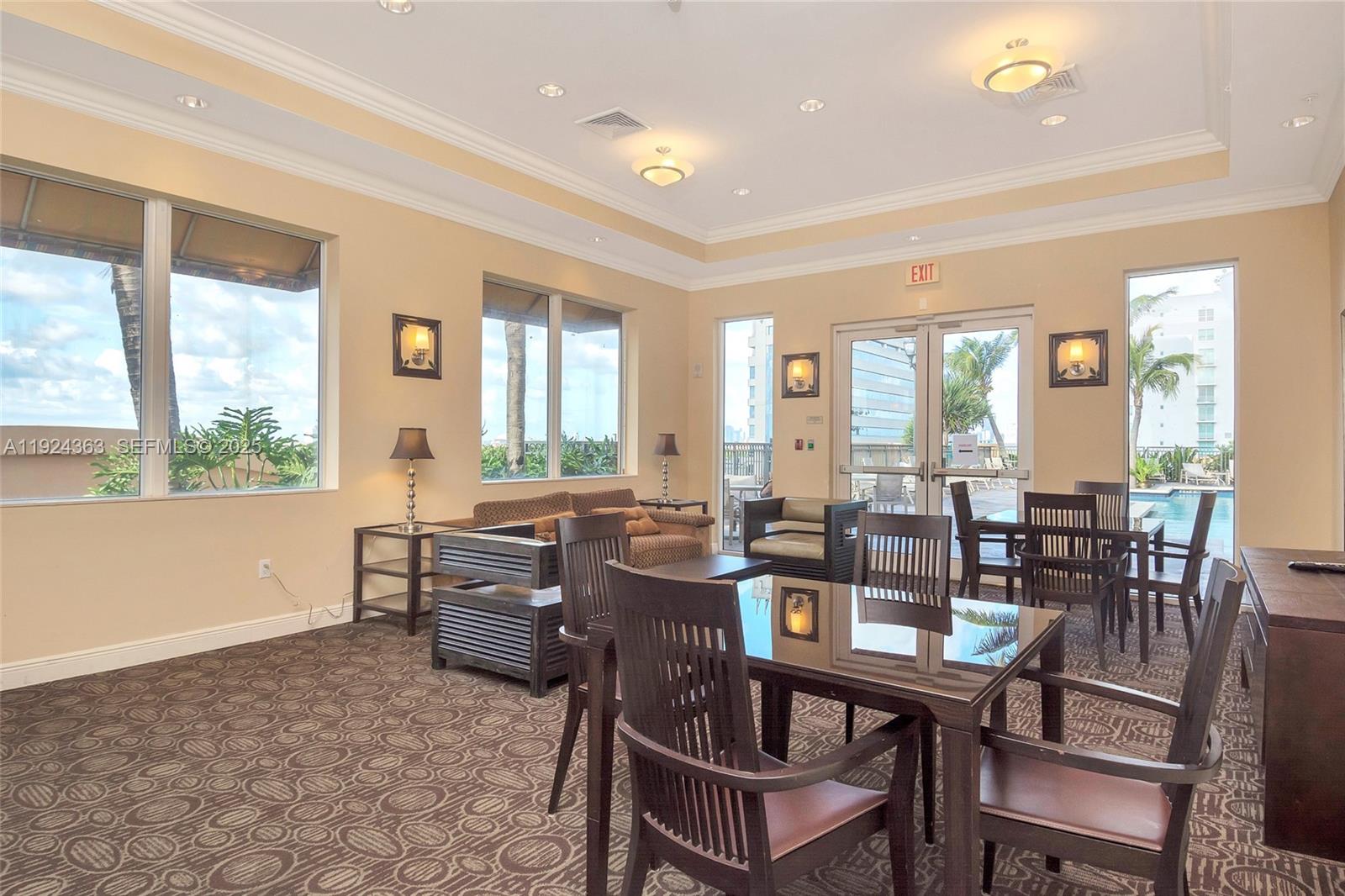 3232 Southwest 22nd Street, Unit 905 Miami, FL 33145 - Photo 22 of 24 a room with lots of tables a large window and chairs