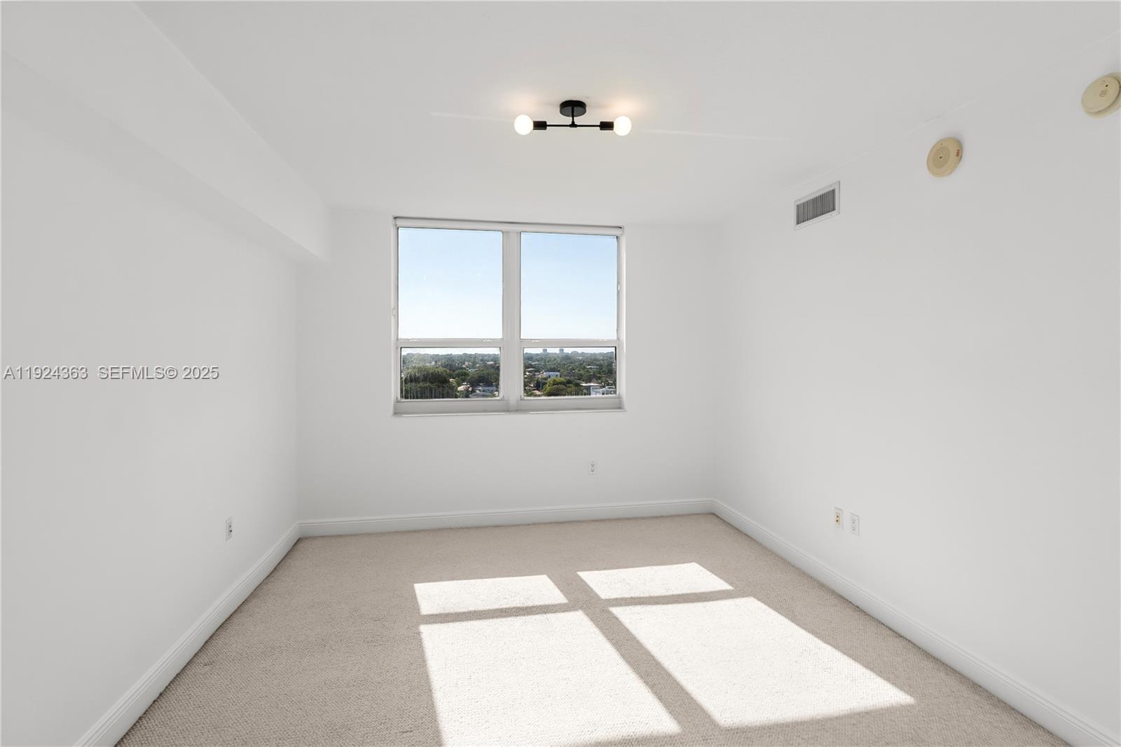 3232 Southwest 22nd Street, Unit 905 Miami, FL 33145 - Photo 9 of 24 an empty room with a window