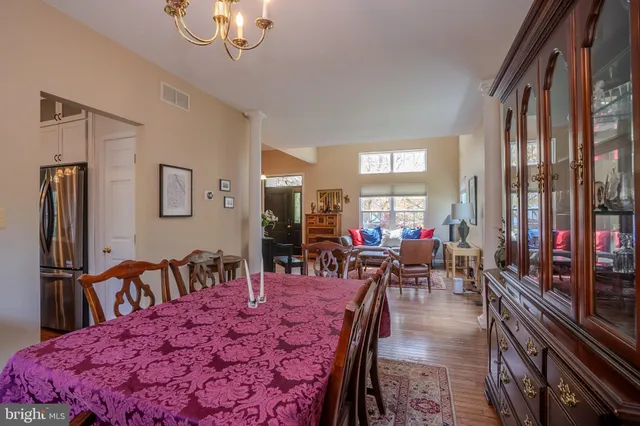 a view of hallway with stairs and wooden floor