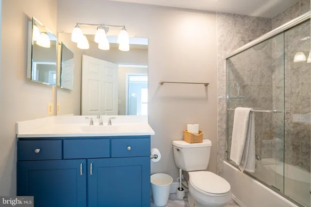 an aerial view of residential houses with outdoor space and trees all around