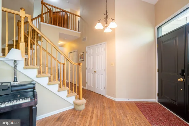 a living room with furniture a flat screen tv and a window