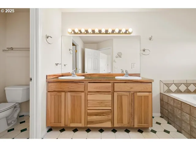 a bathroom with a sink vanity and mirror