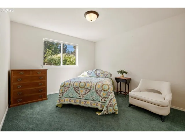 a bedroom with a bed and a chair